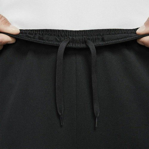 Black pants with drawstring waistband held by a person, Man wearing a black Nike tracksuit, Nike, tracksuit, F1 merch, winter exercise clothes, men jersey, mens track pants, adidas, Ferrari, Lamborghini,  motogp, brand clothes